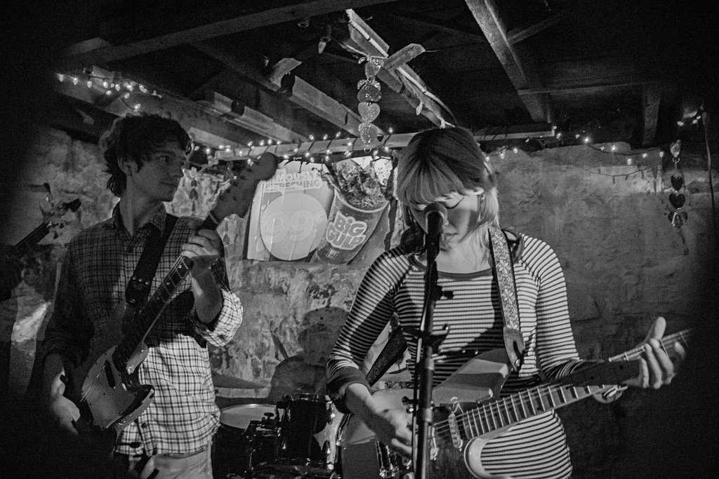 first known use playing live under string lights, two guitars at the microphone